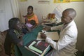 A doctor consults with mother and children about HIV/AIDS at Pepo La Tumaini Jangwani, HIV/AIDS Community Rehabilitation Program, Royalty Free Stock Photo