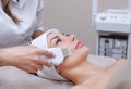 The doctor-cosmetologist makes the apparatus a procedure of ultrasound cleaning of the facial skin of a beautiful, young woman Royalty Free Stock Photo