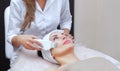 The doctor-cosmetologist makes the apparatus a procedure of ultrasound cleaning of the facial skin of a beautiful, young woman Royalty Free Stock Photo