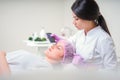 Hands of cosmetologist making ultrasound facial cleaning with special machine Royalty Free Stock Photo