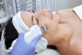 The doctor-cosmetologist makes the apparatus a procedure of ultrasound cleaning of the facial skin Royalty Free Stock Photo