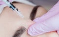 The doctor cosmetologist makes the Botulinum Toxin injection procedure