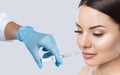 The doctor cosmetologist makes Lip augmentation procedure of a beautiful woman in a beauty salon.Cosmetology skin care