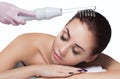 The doctor-cosmetologist makes the procedure Microcurrent therapy On the hair of a beautiful, young woman in a beauty salon Royalty Free Stock Photo