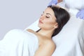 The doctor-cosmetologist makes the procedure Microcurrent therapy On the hair of a beautiful, young woman in a beauty salon Royalty Free Stock Photo