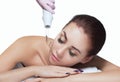 The doctor-cosmetologist makes the procedure Microcurrent therapy On the hair of a beautiful, young woman in a beauty salon Royalty Free Stock Photo