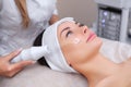 The doctor-cosmetologist makes the procedure Microcurrent therapy On the hair of a beautiful, young woman Royalty Free Stock Photo