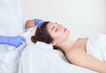 The doctor-cosmetologist makes the procedure Microcurrent therapy on the scalp of a beautiful, young woman in a beauty salon. Royalty Free Stock Photo