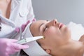 The doctor-cosmetologist makes the procedure treatment of Couperose of the facial skin of a beautiful, young woman in a beauty Royalty Free Stock Photo