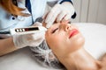 The doctor cosmetologist makes the Rejuvenating facial injections procedure for tightening and smoothing wrinkles on the Royalty Free Stock Photo