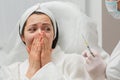 The doctor cosmetologist makes the rejuvenating facial injections procedure for tightening and smoothing wrinkles on the