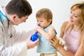 Doctor counseling mother and child about nasal irrigation or douch Royalty Free Stock Photo