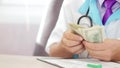 Doctor counting money. Concept of corruption or expensive healthcare Royalty Free Stock Photo