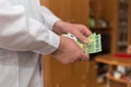 Doctor counting 100 Euro banknotes. Paid medical services healthcare concept Royalty Free Stock Photo