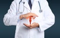 Doctor demonstrating virtual icon with illustration of female reproductive system on dark background, closeup. Gynecological care