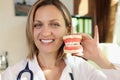 Doctor dentist holding in hands artificial model of human jaw