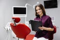 Doctor dentist working in office, using clipboard and making notes Royalty Free Stock Photo