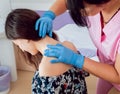 Doctor dermatologist examines birthmark of patient. Checking benign moles Royalty Free Stock Photo