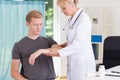 Doctor diagnosing broken arm Royalty Free Stock Photo