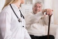 Doctor diagnosing disabled man