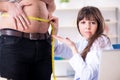 The doctor dietician giving advices to fat overweight patient