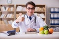 The doctor in dieting concept with fruits and vegetables