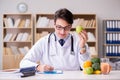 The doctor in dieting concept with fruits and vegetables