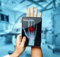 Doctor With Digital Tablet Scans Patient Hand, Modern X-Ray Technology In Medicine Concept Royalty Free Stock Photo