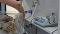 The doctor disconnects the tubes connected to the newborn premature baby in the incubator. intensive care unit for children. 4k. 4