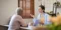 doctor discussion results or symptoms and gives Give advice about medicine to a senior women patient, giving Royalty Free Stock Photo