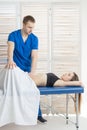 The doctor does diagnostics of muscles of an abdominal cavity of the patient. Removal of tension of muscles of a stomach Royalty Free Stock Photo