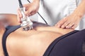 The doctor does the Rf lifting procedure on the stomach and hips of a woman in a beauty parlor. Royalty Free Stock Photo