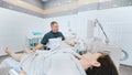 doctor does an ultrasound of the veins on the patient's legs. A phlebologist checks the veins on a woman's legs