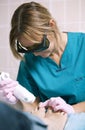 Doctor doing a laser treatment on a womans foot