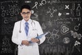 Doctor with doodle on the blackboard Royalty Free Stock Photo