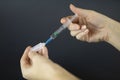 The doctor draws the vaccine from the ampoule with a medical syringe. Royalty Free Stock Photo