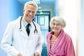 Doctor with Elderly Female Smiling. Royalty Free Stock Photo