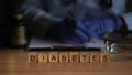 Doctor endocrinologist writing out prescription on background of wooden cubes with word diabetes closeup Royalty Free Stock Photo