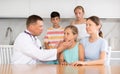 Doctor examinating pre-teen girl