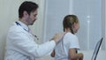 Doctor examines the child`s back, pediatrician examining a girl.