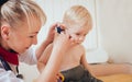 Doctor examines ear with otoscope in a pediatrician room. Royalty Free Stock Photo