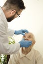 Doctor examines the eyes, conjunctival very old woman The doctor geriatrician during the test.