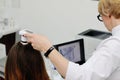 Doctor examines the hairy part of the patient`s head