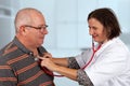 Doctor examines lungs with stethoscope