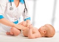 Doctor examines, massaging baby tummy Royalty Free Stock Photo