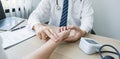 The doctor examines the patient's pulse by hand and records the results, health medical checkup concept Royalty Free Stock Photo