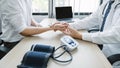 The doctor examines the patient's pulse by hand and records the results, health medical checkup concept Royalty Free Stock Photo