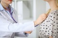 Doctor examines a patient with a stethoscope