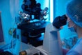 Embryologist using a specialized microscope in a lab Royalty Free Stock Photo