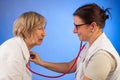 Doctor examines senior woman with a stethoscope